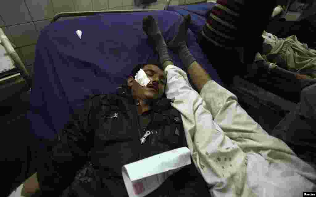 Injured men lie on a bed in a hospital in Peshawar, Pakistan, Feb. 2, 2014.