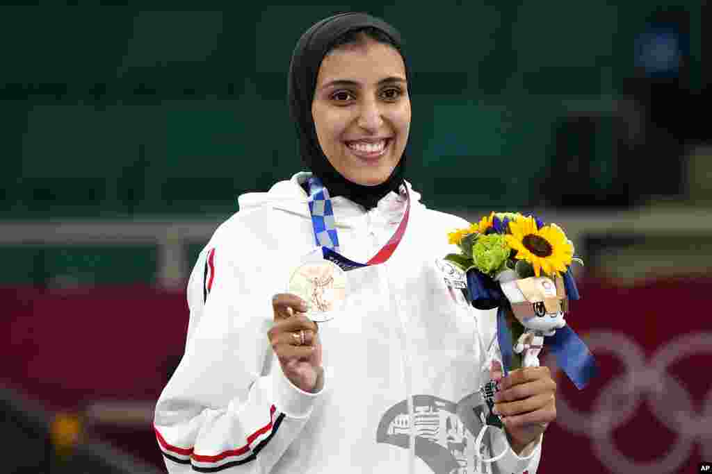 Bronze medalist Giana Lotfy of Egypt poses during the medal ceremony for women's kumite -61kg karate at the 2020 Summer Olympics, Friday, Aug. 6, 2021, in Tokyo, Japan. (AP Photo/Vincent Thian)