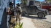 Police stand guard in front of the Police Academy during a funeral of three police officers killed in the line of duty in Port-au-Prince, Haiti, Jan. 31, 2023. On April 9, 2023 three more officers were killed in an ambush.