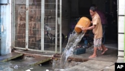 A man cleans his flood-damaged house in Jakarta, Indonesia, Jan. 5, 2020. 