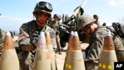 FILE - South Korean army soldiers arrange 155mm howitzer shells during a military exercise in Goseong, South Korea, on April 4, 2016.