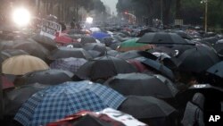 Para pengunjuk rasa berpawai di Tirana, 13 Mei 2019. Para pengunjuk rasa anti-pemerintah melemparkan bom molotiv dan lampu suar ke arah politi anti huru-hara di depan gedung pemerintah.