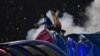Penonton bereaksi ketika gas air mata dilepaskan oleh polisi setelah pertandingan sepak bola antara Arema FC dan Persebaya di stadion Kanjuruhan di Malang, Jawa Timur. (Foto: AFP)