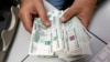 Russian Ruble Firms as Oil, Taxes and Carry Trade Support