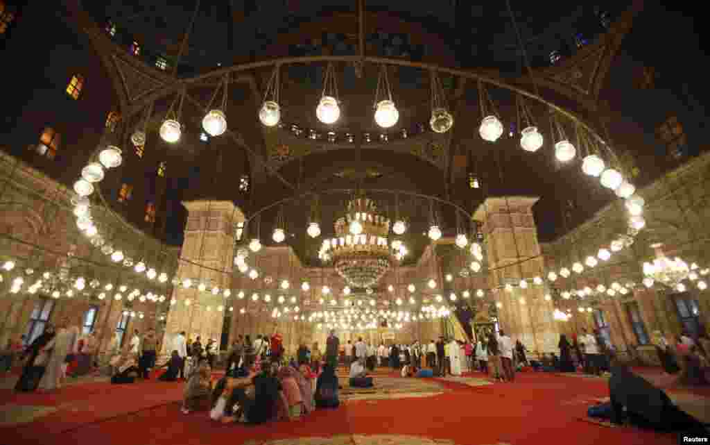 Egyptians rest after Eid al-Fitr prayer at the Mosque of Mohamed Ali Pasha, situated on the summit of the ancient citadel of Salah Addin Alayoubi, in Cairo, August 19, 2012.