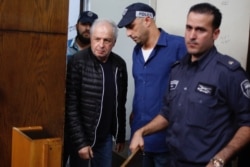 FILE - Bezeq telecom company's controlling shareholder Shaul Elovitch arrives to the magistrate court in Tel Aviv, Israel, Feb. 22, 2018.