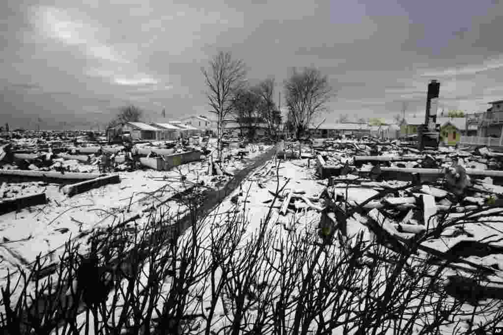 The fire-scorched landscape of Breezy Point in New York, which was devastated during Superstorm Sandy when a fire pushed by the raging winds destroyed many homes, is seen after a Nor'easter snow, November 8, 2012.
