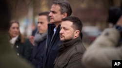 Ukrainian President Volodymyr Zelenskyy, center right, and Greek Prime Minister Kyriakos Mitsotakis visit the site of a Russian attack at a residential area in Odesa, Ukraine, on March 6, 2024.