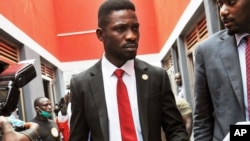 FILE - Bobi Wine, center, arrives to speak at the National Unity Platform head office in Kampala, Uganda, Aug. 31, 2020. Wine recently asked his followers on social media to financially support the party's parliamentary candidates. 