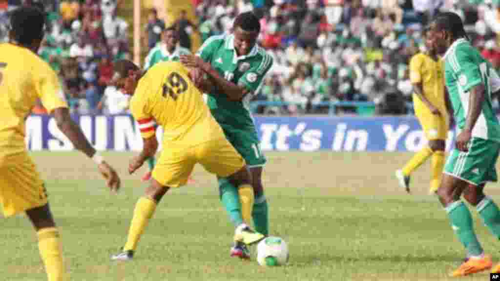 Nigeria's Victor Moses, right, Mikel John Obi, centre, is challenged by Ethiopia's Adane Girma, and Aynalem Bancha, left, during their 2014 World Cup qualifying playoff match.