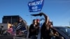 Supporters of President Donald Trump attend a rally and car parade Saturday, Aug. 29, 2020, in Clackamas, Ore., on the way to Portland. (AP Photo/Paula Bronstein )