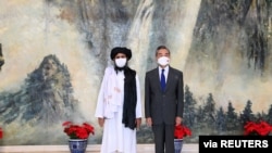 Chinese State Councilor and Foreign Minister Wang Yi meets with Mullah Abdul Ghani Baradar, political chief of Afghanistan's Taliban, in Tianjin, China, July 28, 2021.