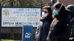 FILE - Nurses and community faith leaders protest outside the Cook County Jail in Chicago, April 10, 2020, calling for the release of prisoners amid the coronavirus pandemic.