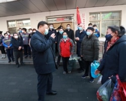 Chinese President Xi Jinping inspects the novel coronavirus prevention and control work at Anhuali Community in Beijing, China, Feb. 10, 2020.