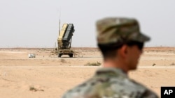 A member of the U.S. Air Force stands near a Patriot missile battery at the Prince Sultan air base in al-Kharj, central Saudi Arabia, Thursday, February 20, 2020. Pompeo met with King Salman in the capital, Riyadh, on Thursday. (Andrew Caballero…