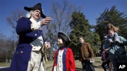 Lewis Bliss, 10, of Burke, Va., dressed in a musicians outfit from the Revolutionary War era, center, meets George Washington, portrayed by Dean Malissa, during Presidents Day activities at George Washington's Mount Vernon Estate in Mount Vernon, Virginia