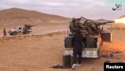 A still image taken from a video released by Islamic State-affiliated Amaq news agency Dec. 10, 2016, purports to show Islamic State fighters advancing over the Hayan mountain south of Palmyra, Syria. 