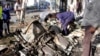 Somalian police examine the wreckage of the car after car bomb exploded in Mogadishu, Somalia, April 17, 2019.