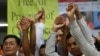 Members of the opposition Cambodia National Rescue Party (CNRP), raise joined hands for photographs at their party headquarters in Phnom Penh, Cambodia, Friday, May 27, 2016. A Cambodian court on Friday convicted three military commandos of beating up two CNRP lawmakers outside the parliament last year, and sentenced them to one year each in prison. The legislators' lawyer called the punishment too lenient. (AP Photo/Heng Sinith)