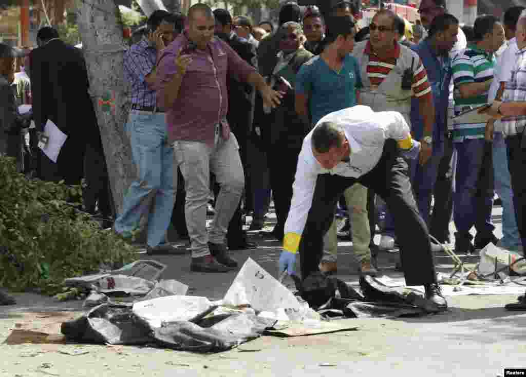 Forensic workers and policemen carry out investigations at the scene of a bomb blast in Cairo.