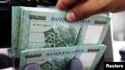 FILE - Lebanese pound banknotes are seen at a currency exchange shop in Beirut, Lebanon, June 15, 2020. 