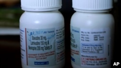 FILE - bottles containing antiretroviral drugs marked for a young HIV-positive patient in India stand on a table in Ukhrul, in the northeastern Indian state of Manipur.