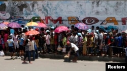 Evacuees queue for relief goods in a sports stadium which has been turned into an evacuation center Zamboanga, Sept. 20, 2013.