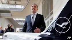 FILE - CEO of German Lufthansa airline Carsten Spohr stands next to a model of a Boeing 747 prior to a press conference in Frankfurt, Germany, March 15, 2018.