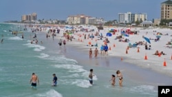 People enjoy their time in the sun on Clearwater Beach in Clearwater, Florida on March 2, 2021. (AP File Photo)