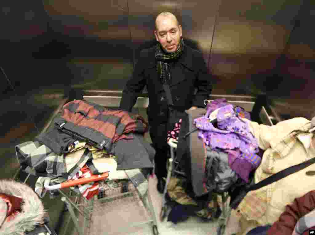 Manuel Diaz Escobar, a tourist from Mexico City, rides in an elevator with his purchases from Kmart, New York, Nov. 28, 2013.