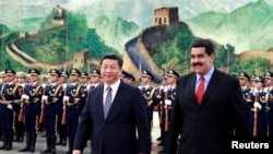 Venezuelan President Nicolas Maduro, right, walks with China's President Xi Jinping during welcome ceremony, Great Hall of the People, Beijing, Jan. 7, 2015.