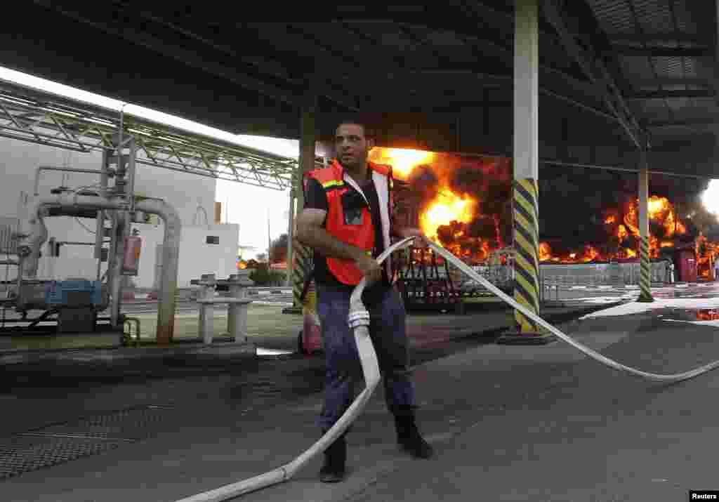 A Palestinian firefighter at Gaza's main power plant, which was hit in Israeli shelling, in the central Gaza Strip, July 29, 2014.