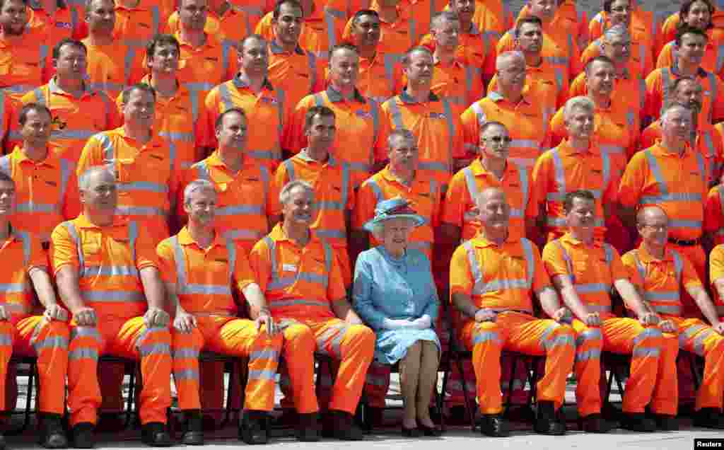 Britain's Queen Elizabeth meets construction workers as she attends the official opening of the refurbished Reading Station, west of London.