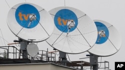 Satellite dishes sit on top of the headquarters of the private TVN broadcaster in Warsaw, Poland, is owned by the U.S. Scripps Networks Interactive, Sept. 12, 2017. 
