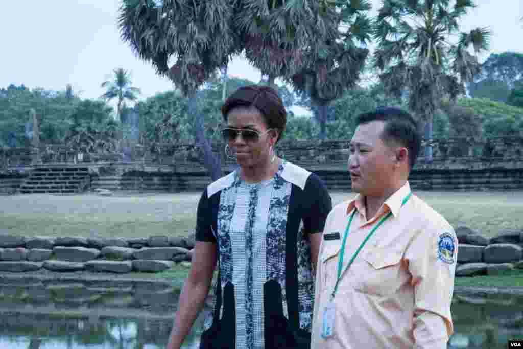 Michelle Obama walks with her tour guide in Angkor Wat compound, March 21, 2015.