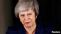Britain's Prime Minister Theresa May speaks outside 10 Downing Street after a confidence vote by Conservative Party Members of Parliament (MPs), in London, Britain, Dec. 12, 2018.