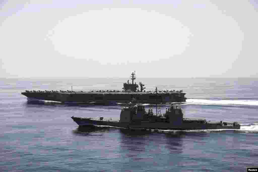 The aircraft carrier USS Theodore Roosevelt (CVN 71) and the guided-missile cruiser USS Normandy (CG 60) conduct maritime security operations in the Arabian Sea, April 21, 2015. (U.S. Navy)