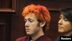 Colorado shooting suspect James Eagan Holmes (L) sits with public defender Tamara Brady during his first court appearance in Aurora, Colorado, July 23, 2012. Holmes, the man accused of shooting dead 12 people in a Colorado movie theater during the midnigh