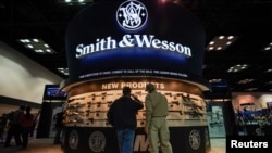 Attendees inspect Smith and Wesson firearms at the National Rifle Association's (NRA) annual meeting, in Indianapolis, Indiana, April 28, 2019.