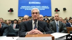 Former special counsel Robert Mueller listens to committee members give their opening remarks before he testifies before the House Intelligence Committee on his report on Russian election interference, on Capitol Hill, in Washington, July 24, 2019.