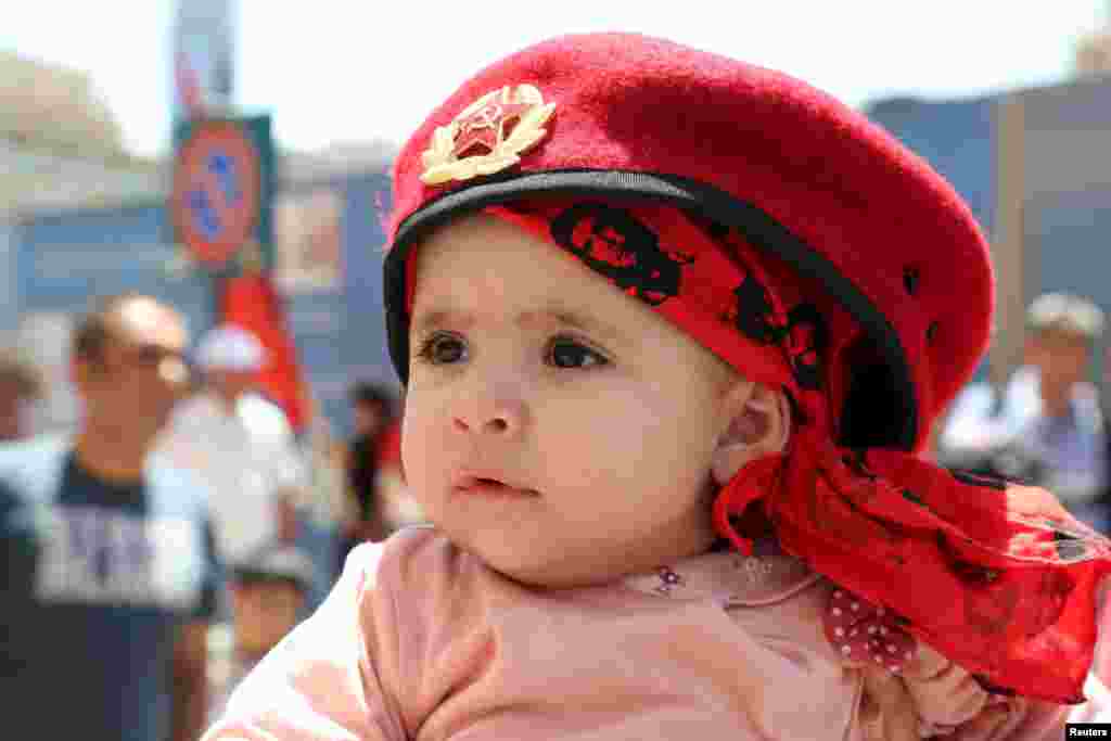 A child attends a march organized by Lebanese Communist party to mark Labour Day in Beirut, May 1, 2015.