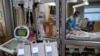 A critical care respiratory therapist works with a COVID-19 patient at Sarasota Memorial Hospital in Sarasota, Florida, February 11, 2021.