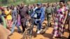 President Pierre Nkurunziza arrives riding a bicycle, accompanied by first lady Denise Bucumi Nkurunziza, right, to cast his vote for the presidential election, in Ngozi, Burundi, July 21, 2015.