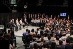 Hong Kong Chief Executive Carrie Lam, center on the stage, attends a community dialogue at the Queen Elizabeth Stadium in Hong Kong, Sept. 26, 2019.