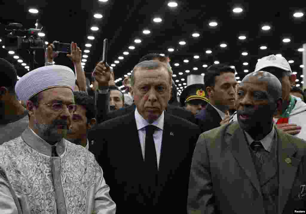 Turkish President Recep Tayyip Erdogan, center, arrives to take part in the Jenazah, an Islamic funeral prayer, for the late boxing champion Muhammad Ali in Louisville, Ky., June 9, 2016.