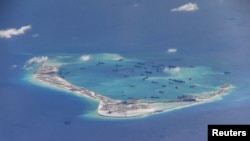 In this May 21, 2015 file photo, Chinese vessels are seen the waters around Mischief Reef in the disputed Spratly Islands in the South China Sea. China has competing claims with many members of ASEAN to parts of the South China Sea. (REUTERS/U.S. Navy/Handout via Reuters)