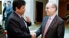 An U.S. Assistant Secretary of State for East Asian and Pacific Affairs Daniel Russel, right, shakes hands with Cambodian Secretary of State of Foreign Ministry Ouch Borith, front left, after a meeting, in Phnom Penh, Cambodia, Tuesday, Jan. 27, 2015. 
