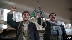 Houthi Shiite fighters chant slogans as they guard a street leading to the residence of former Yemeni President Ali Abdullah Saleh, in Sanaa, Yemen, Dec. 4, 2017. 
