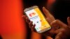 FILE - A woman uses the system Masterpass for payment with phones at the Mobile World Congress, the world's largest mobile phone trade show in Barcelona, Spain, Feb. 25, 2014. 