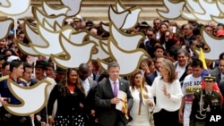 FILE - Colombia's President Juan Manuel Santos carries to Congress the peace deal with rebels of the Revolutionary Armed Forces of Colombia, FARC, in Bogota, Aug. 25, 2016.
